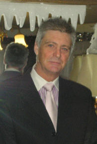 Photo of Barrington Roy Schiller, 
			a white man with gray hair wearing a blue suit